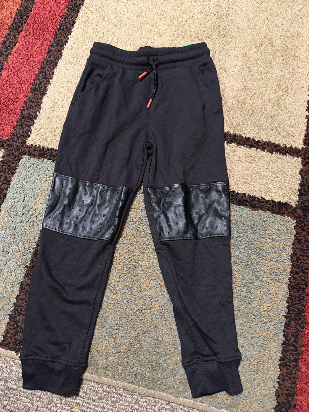 Boys Black joggers with textured leather-like panels on the lower legs size 6 #a